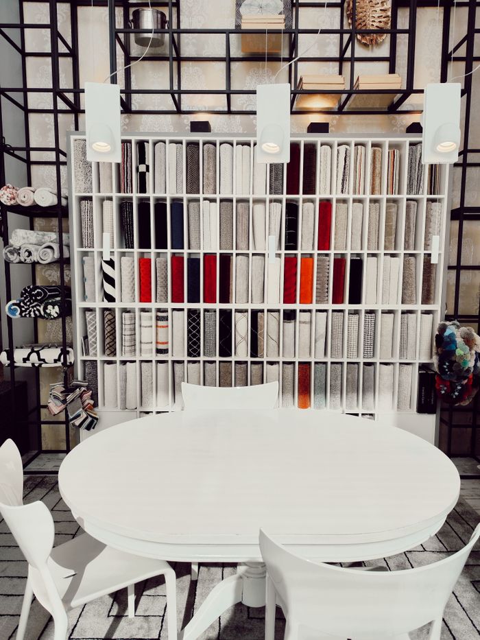 Contemporary interior setting with designer furniture, shelves, and textiles. Ideal for luxury lifestyle concepts.